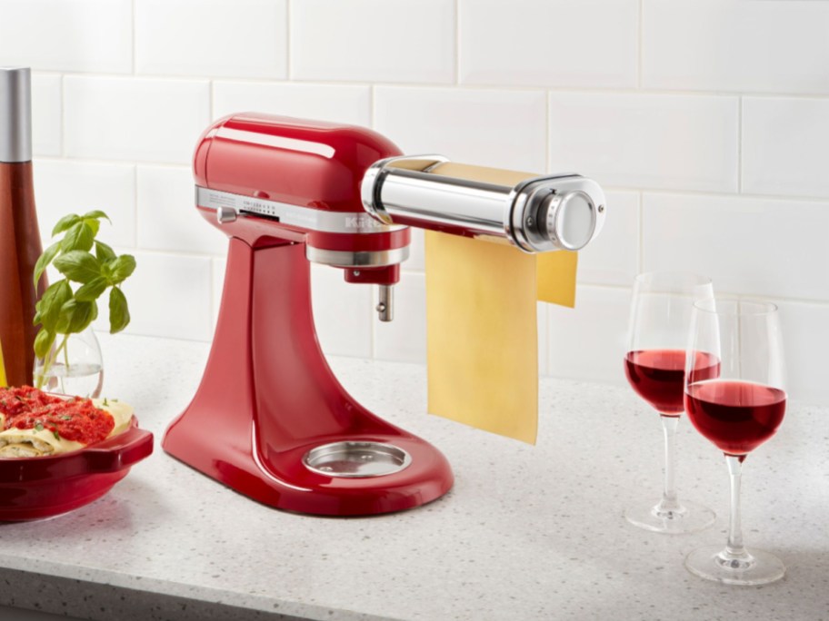 red kitchenaid with Pasta Sheet Roller rolling pasta on countertop