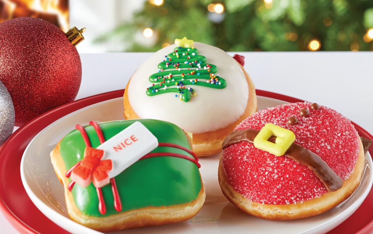 plate with three frosted holiday dougnuts on it