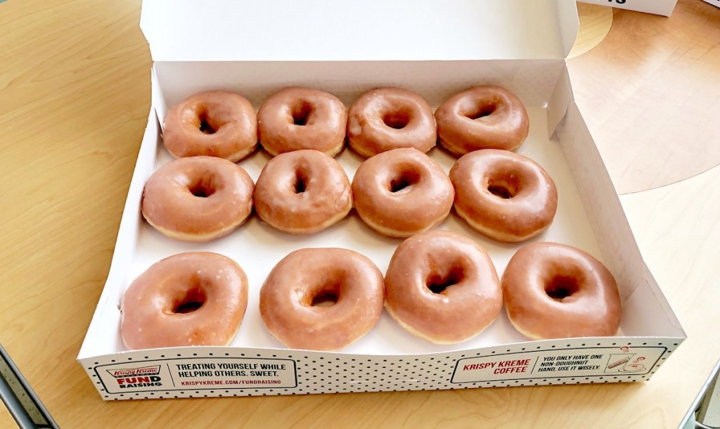 krispy kreme birthday freebies glazed dozen donuts in box on wood table