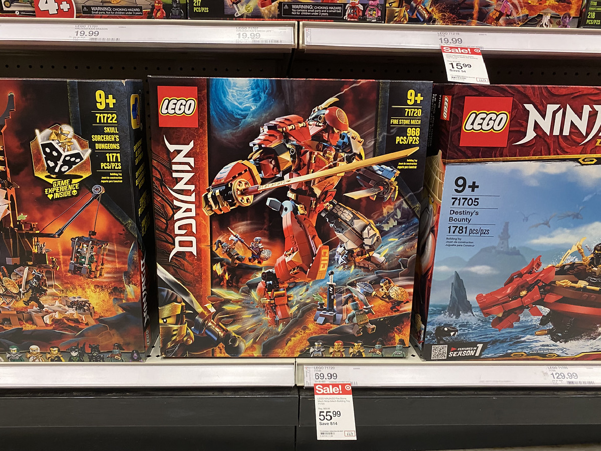 store shelf with prices and boxes of LEGOs