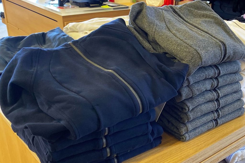 stacks of folded sweatshirts on display