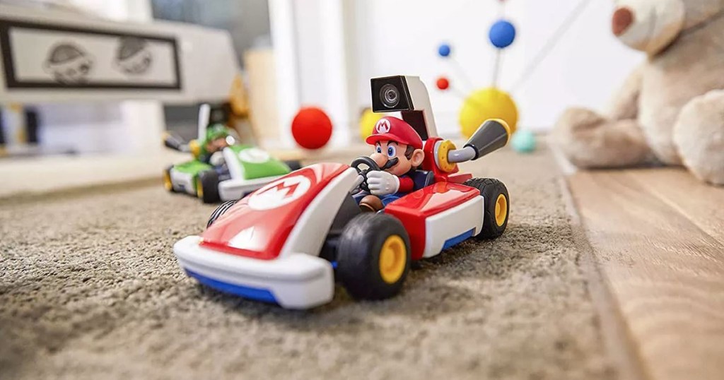 race car with little Mario character in it on kids floor