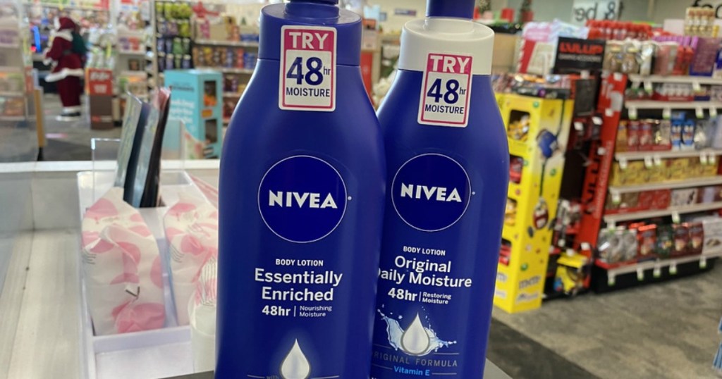 two bottles of nivea body lotion on a store counter