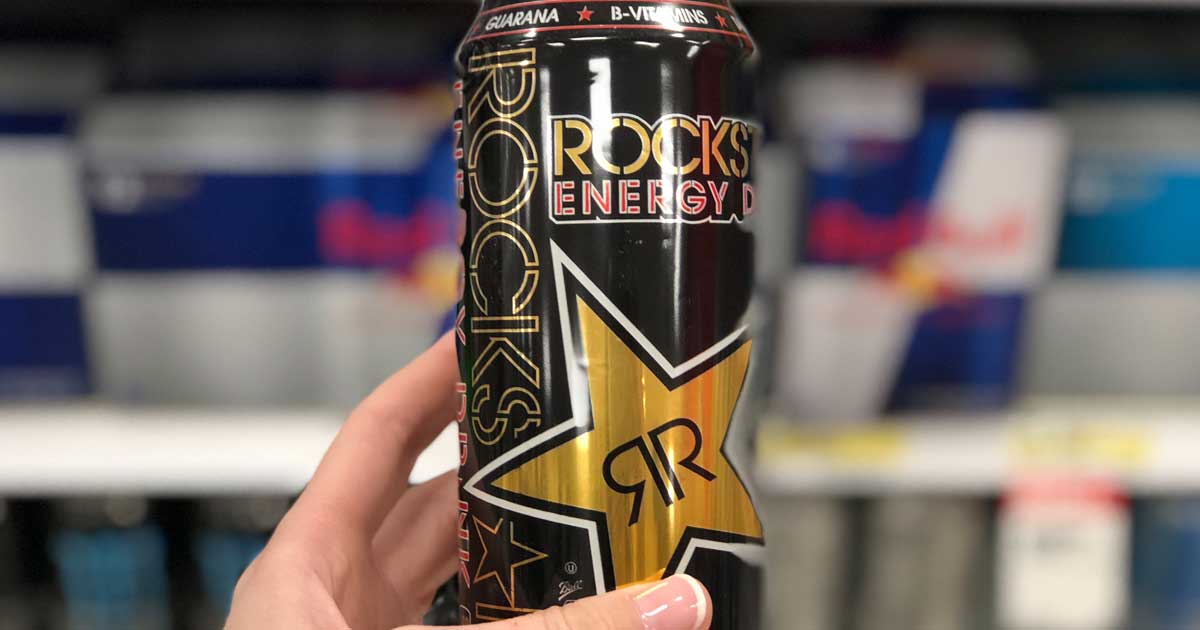 hand holding up a can of rock star energy drink