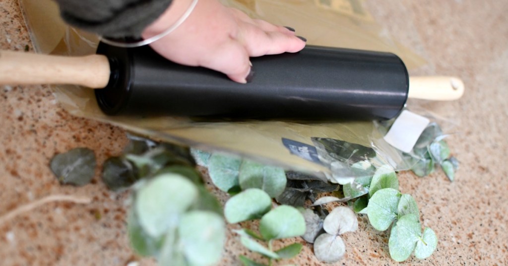 rolling eucalyptus leaves with a rolling pin