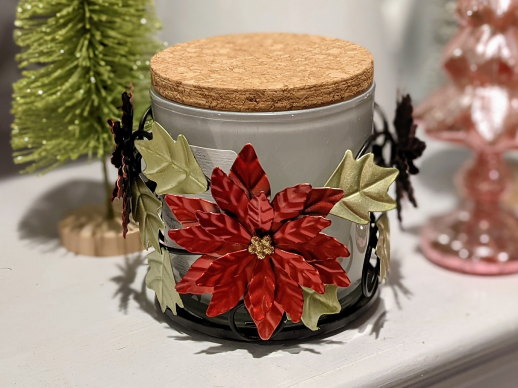 candle holder with poinsettias on it