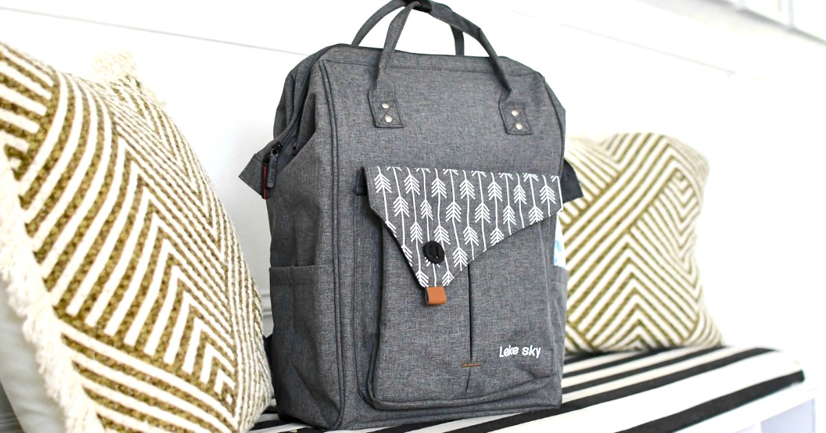 grey travel backpack sitting on entry bench 
