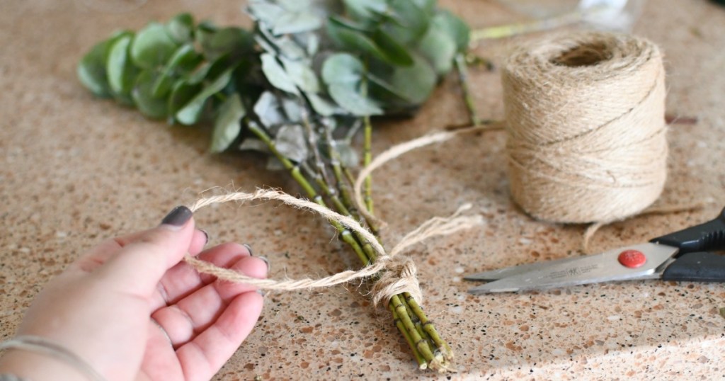 tying eucalyptus leaves together with twine