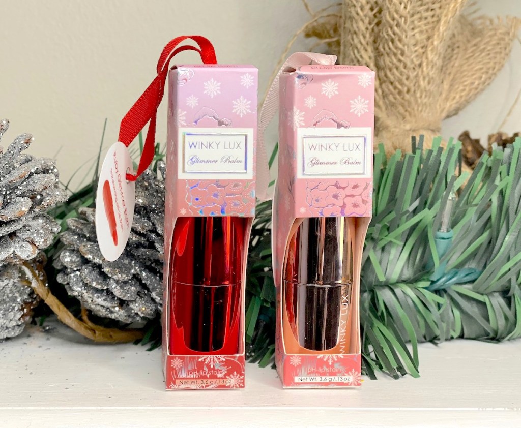 boxes of winky lux lip balm on mantel with christmas decorations