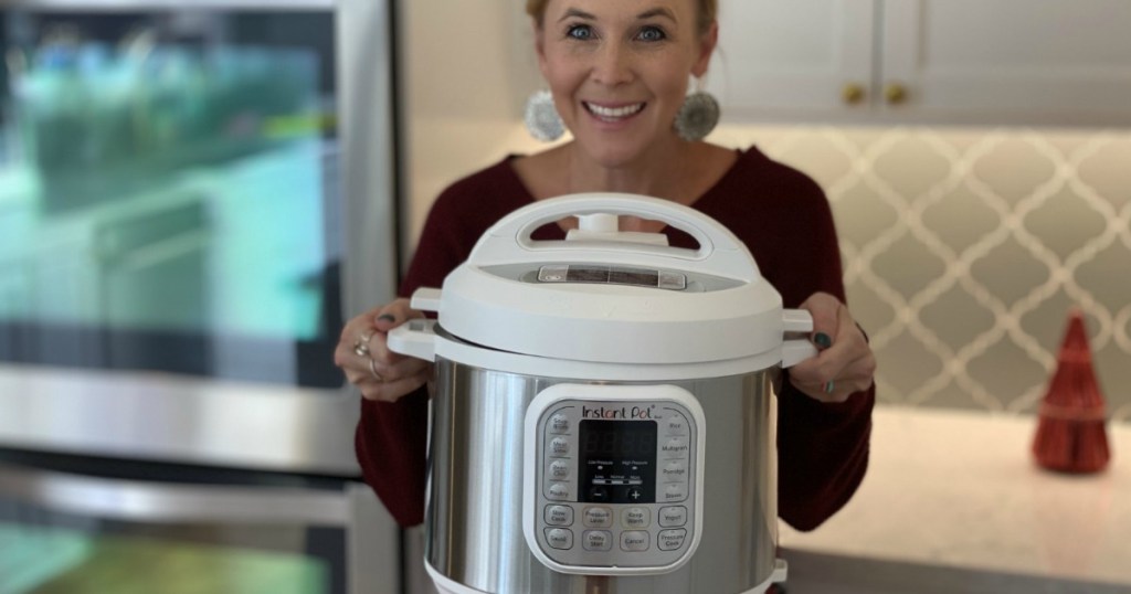 woman holding out white Instant pot 