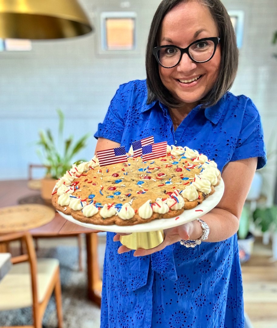 woman holding a 4th of july giant cookie cake