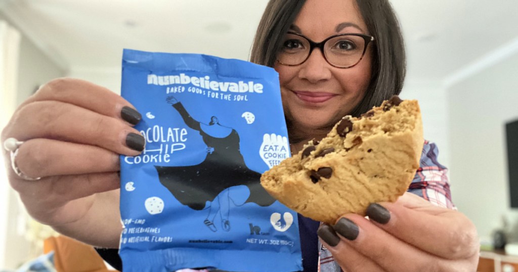 woman holding a nunbelievable cookie
