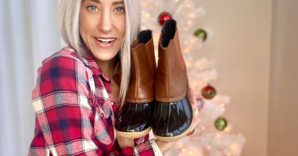 woman holding duck boots 