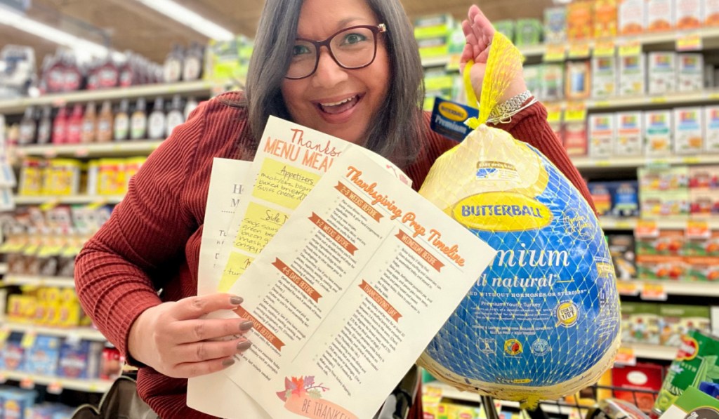 woman holding free thanksgiving printables for thanksgiving prep