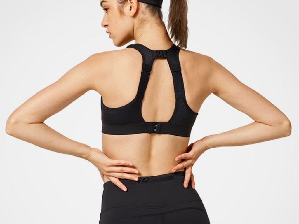 back view of woman wearing black sports bra