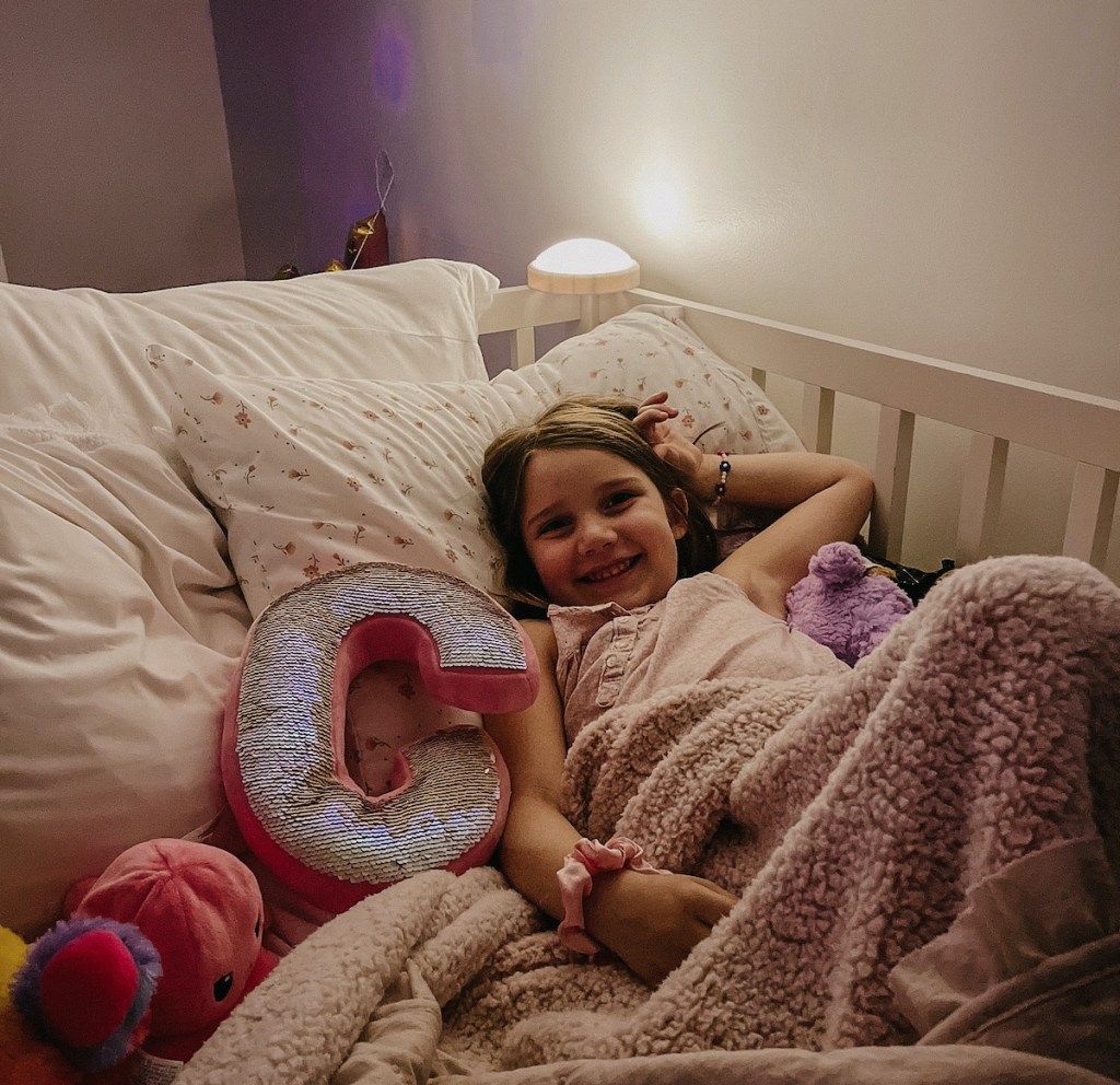 girl laying in bed with nightlight