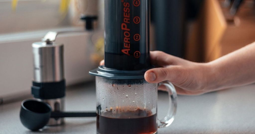 hand making coffee with AeroPress Coffee Maker