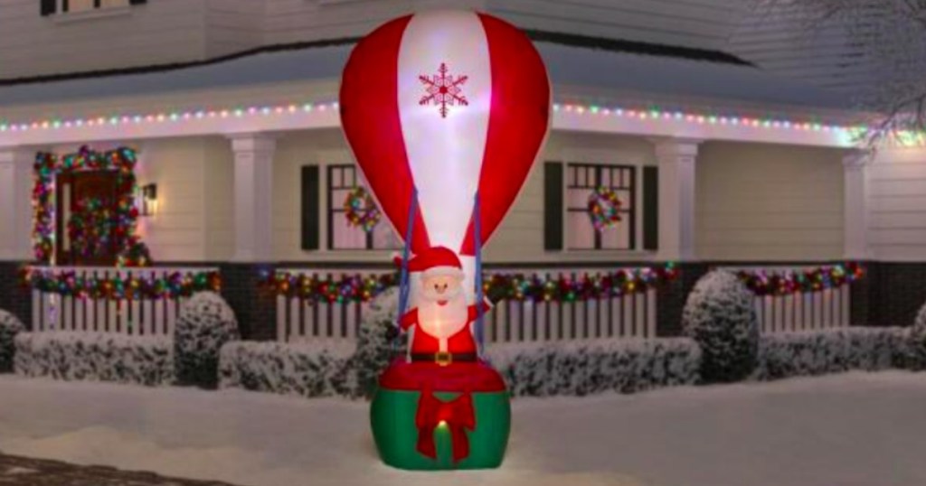 santa air balloon blow up in a front yard with snow