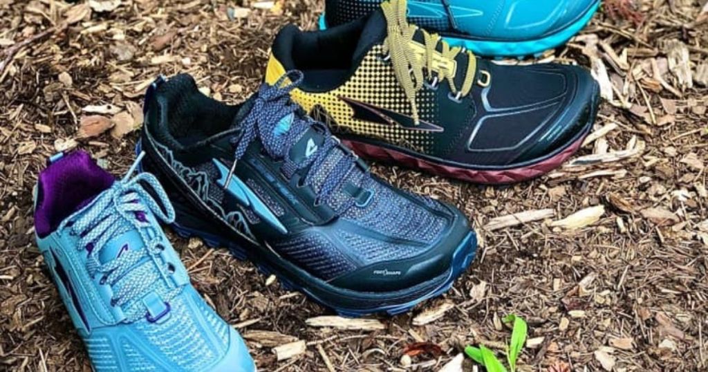 four pairs of altra lone peak trail running shoes in dirt