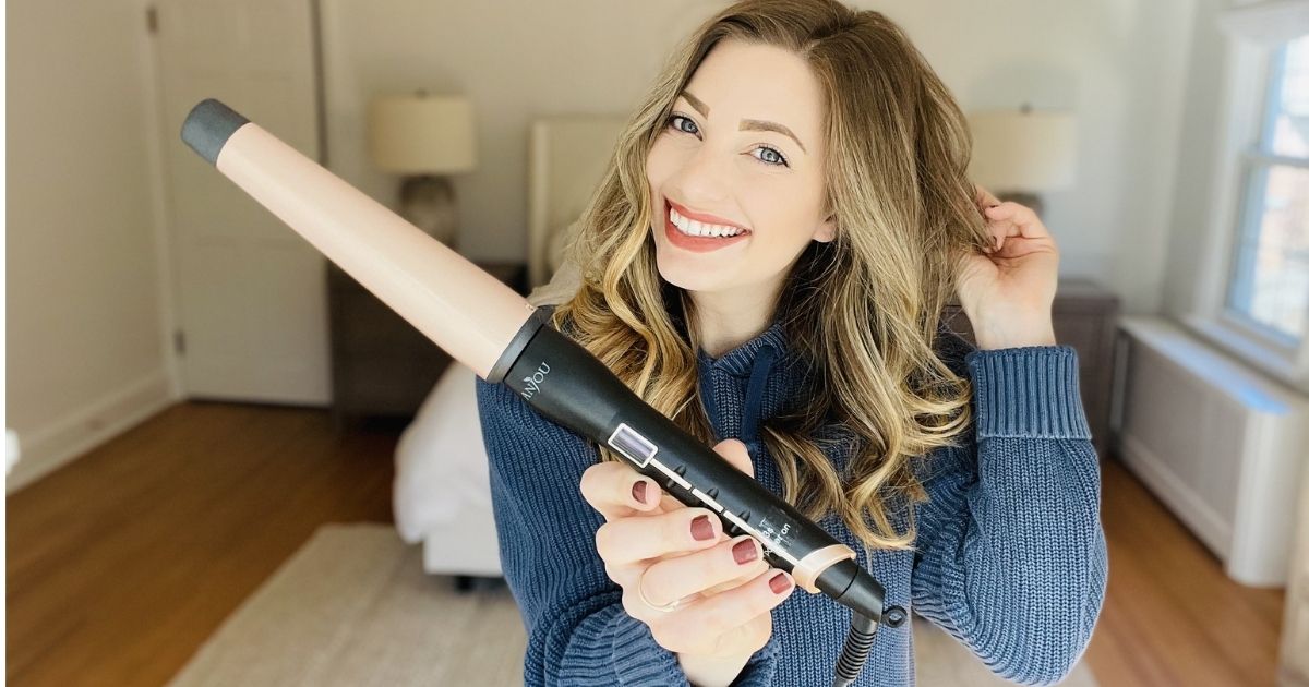 woman holding a curling wand