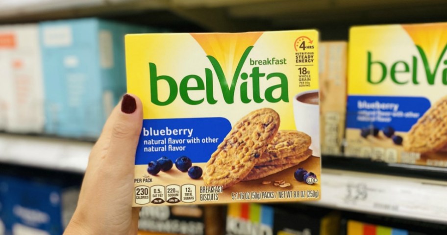 woman's hand holding box of Belvita Blueberry Breakfast Biscuits