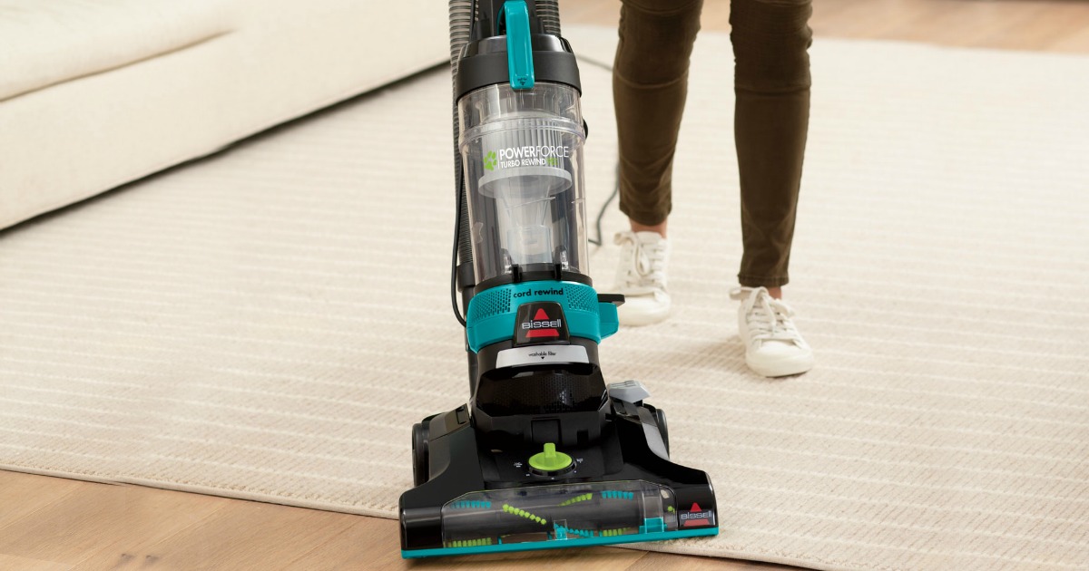 Woman using a BISSELL PowerForce Helix Turbo Rewind Pet Bagless Vacuum