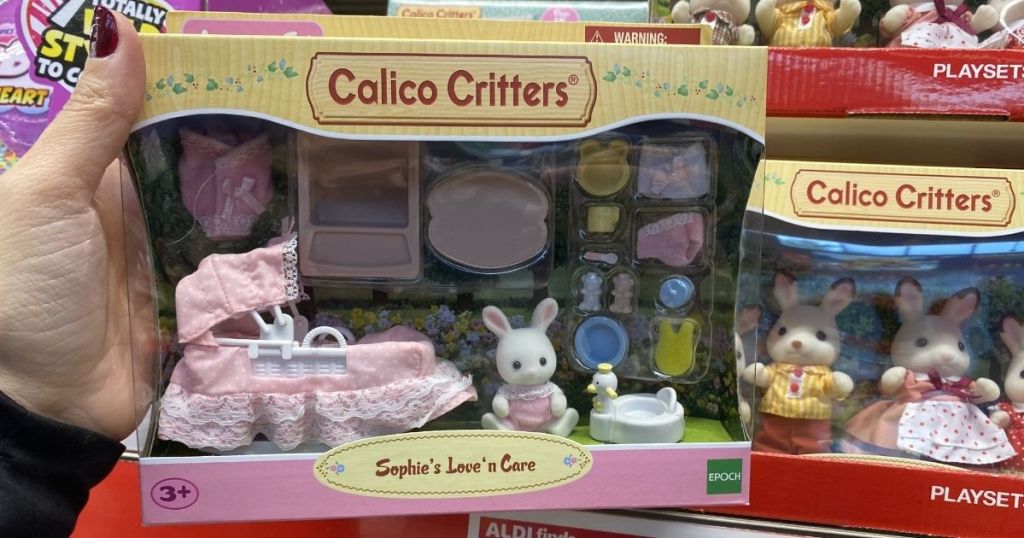 hand holding Calico Critters Sophie's Love 'n Care Set