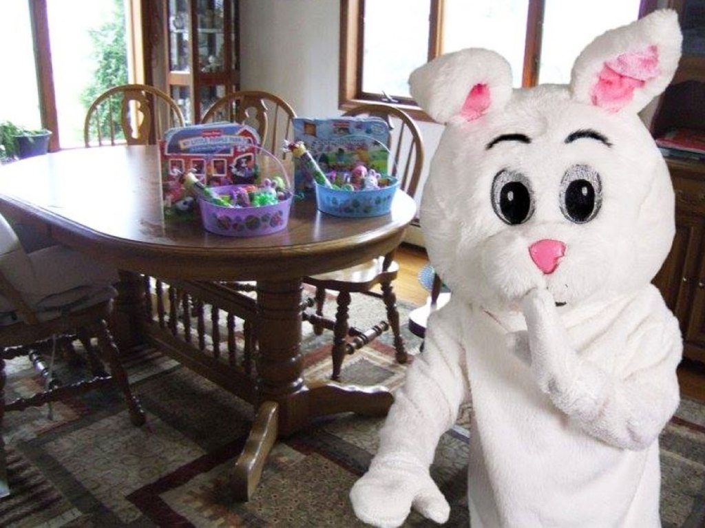 photo of easter bunny standing in front of kitchen table with easter baskets