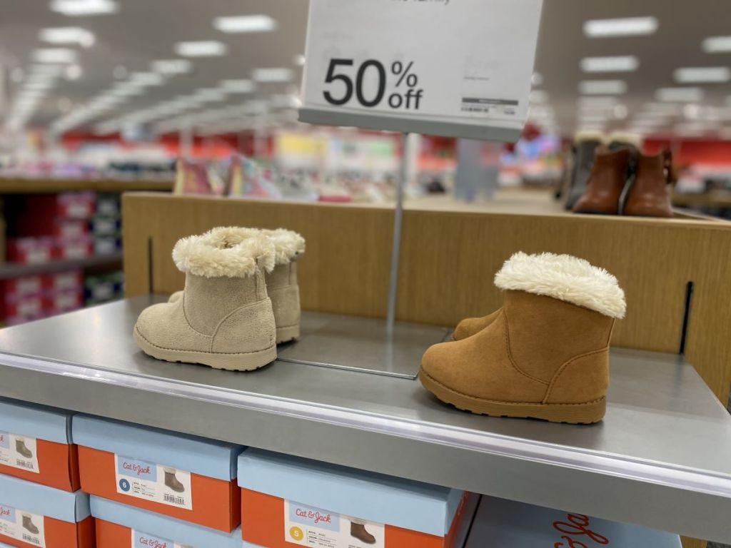 two pairs of boots on a shelf at Target