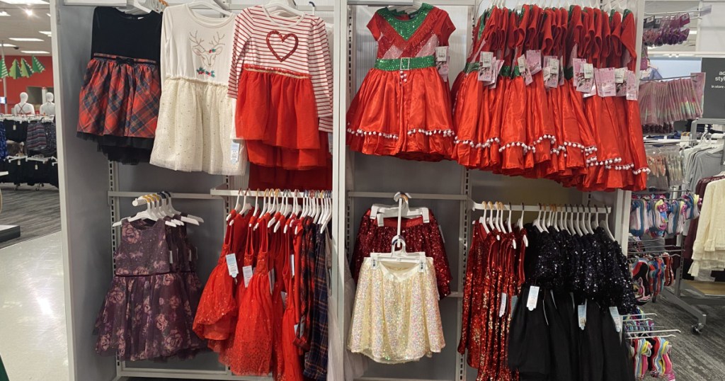girls Christmas themed dresses hanging in store