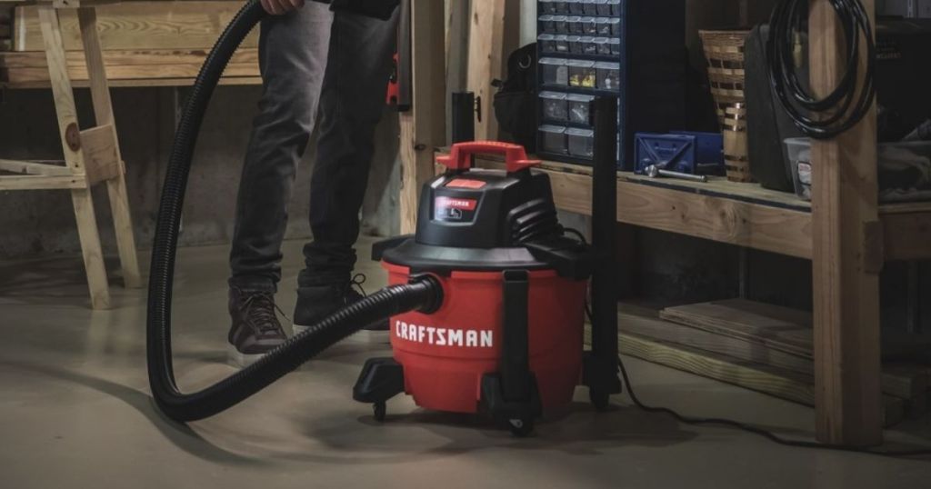 person standing next to a vacuum