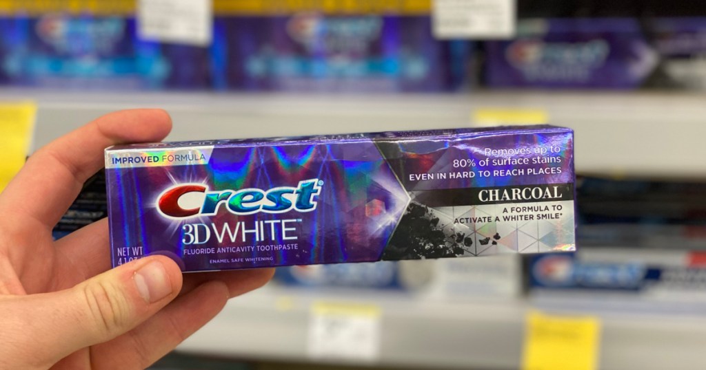 hand holding crest 3d white toothpaste