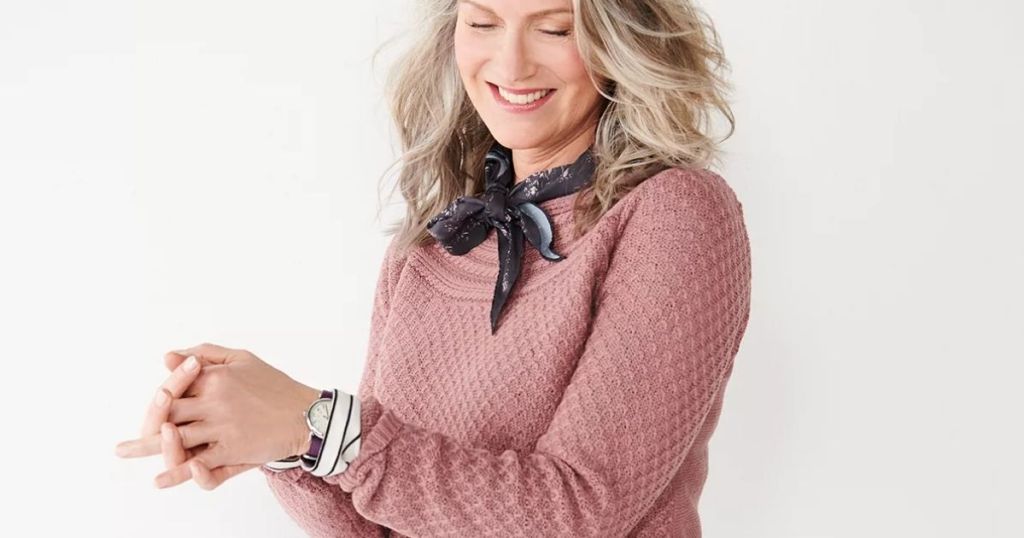woman smiling wearing a sweater