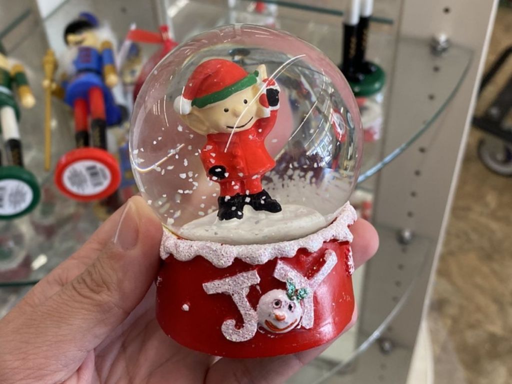 Woman holding Holiday Elf Snow globe