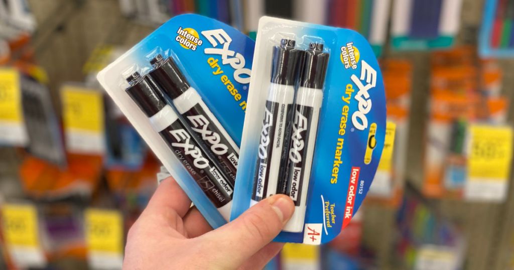 hand holding dry erase markers