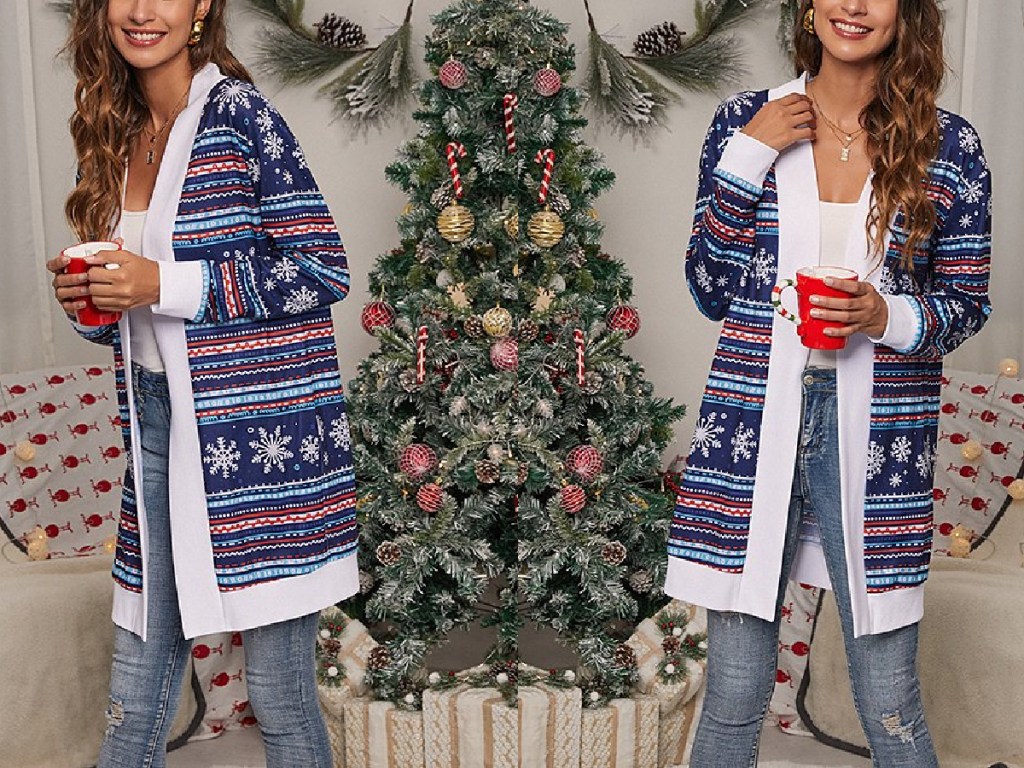 woman next to a christmas tree wearing Floral Blooming Navy Reindeer Fair Isle Open Cardigan