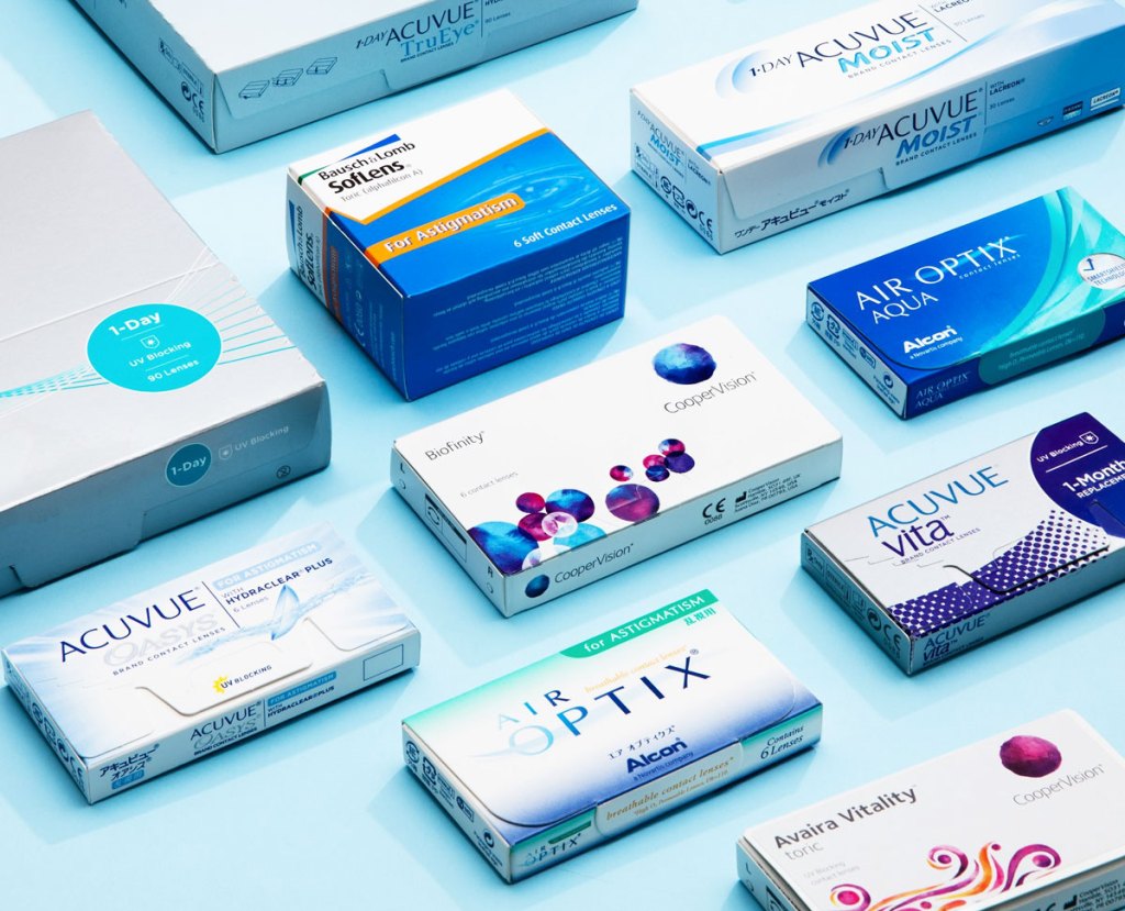 boxes of various brands of contact lenses on a blue background