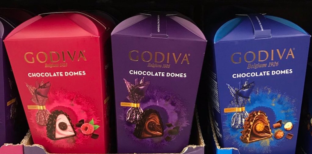 shelf with three boxes of godiva dome chocolates