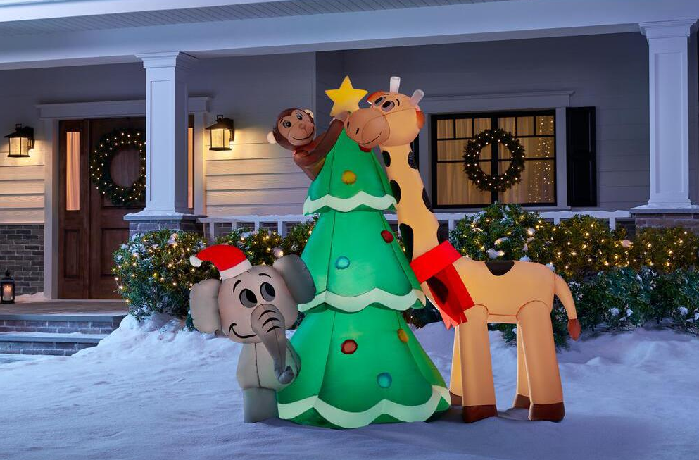 inflatable animals putting a star on a tree