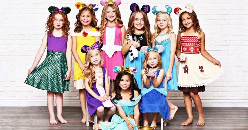 multiple girls showing off disney princess themed dresses and wearing mouse ear headbands