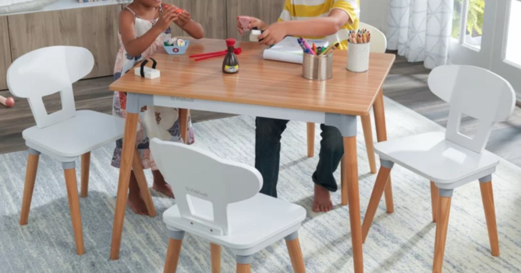 2 children sitting at a kidkraft table and chair set