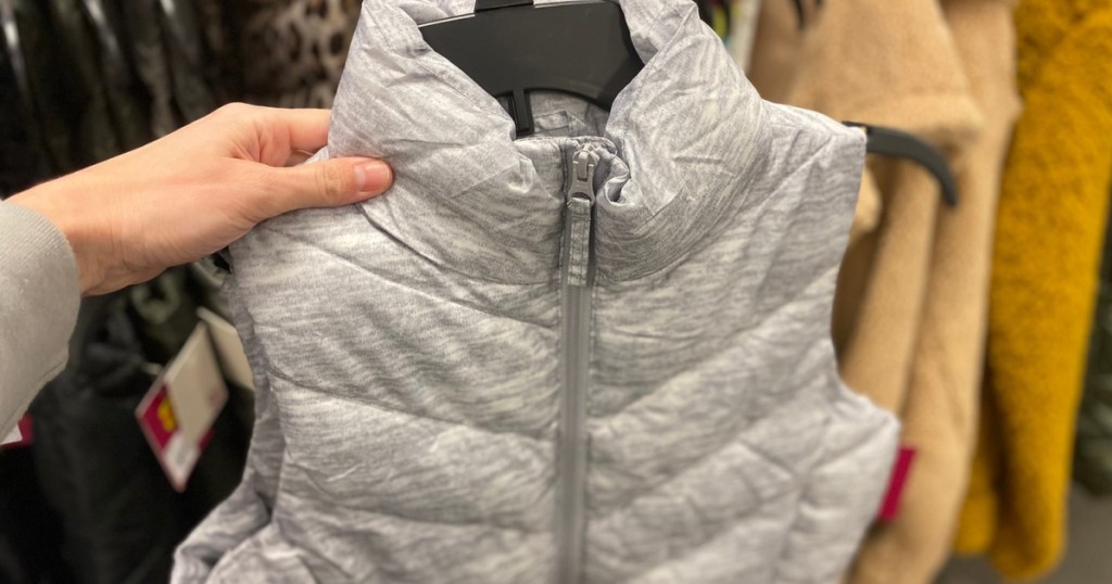 hand holding a woman's light grey puffer vest at kohl's