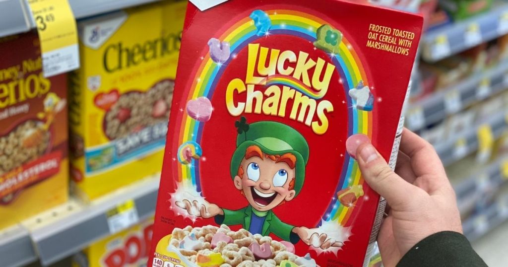 hand holding Lucky Charms Cereal