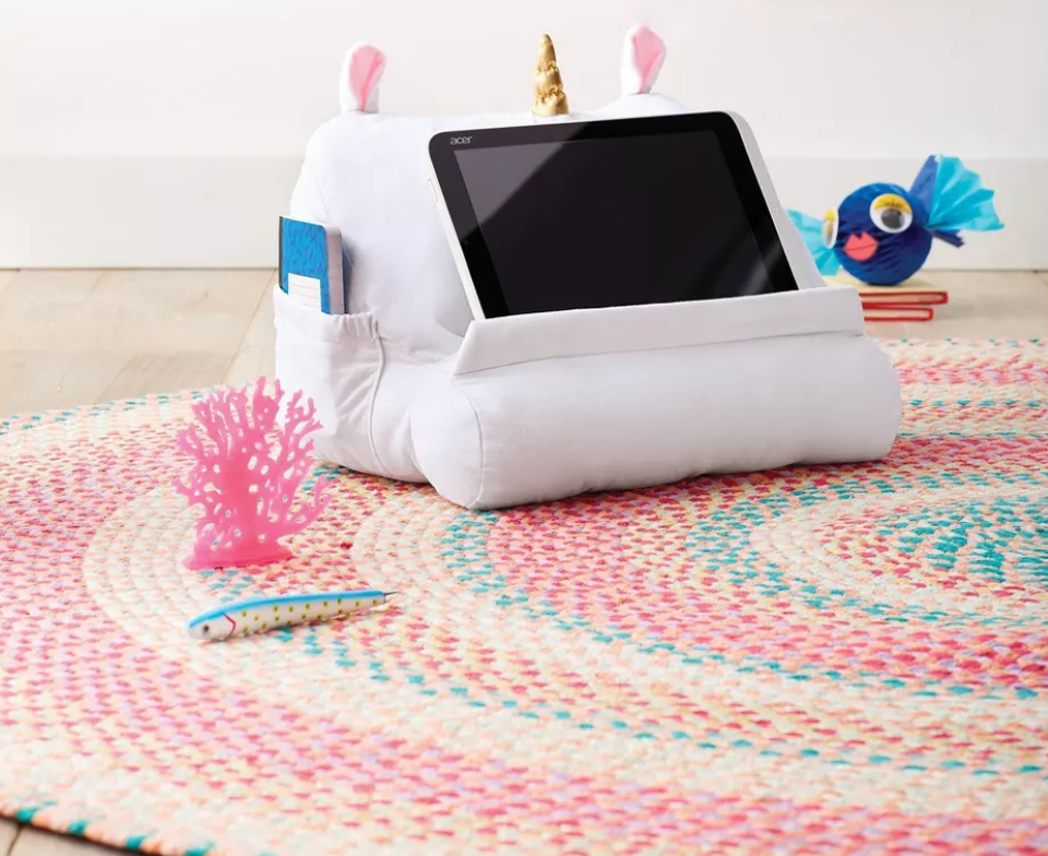 rug on the floor with a tablet stand on it
