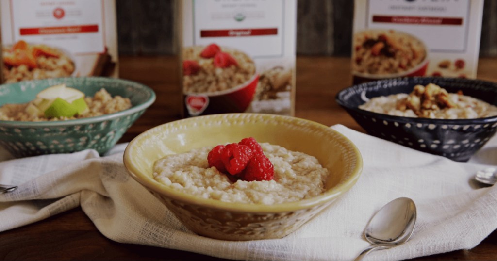 bowls of oatmeal and boxes of oatmeal on table