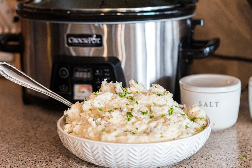 Ranch Mash Potatoes in a bowl next to a slow cooker