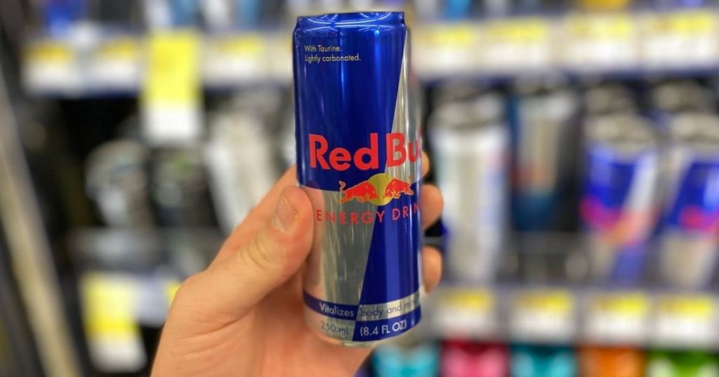 Hand holding a can of red bull