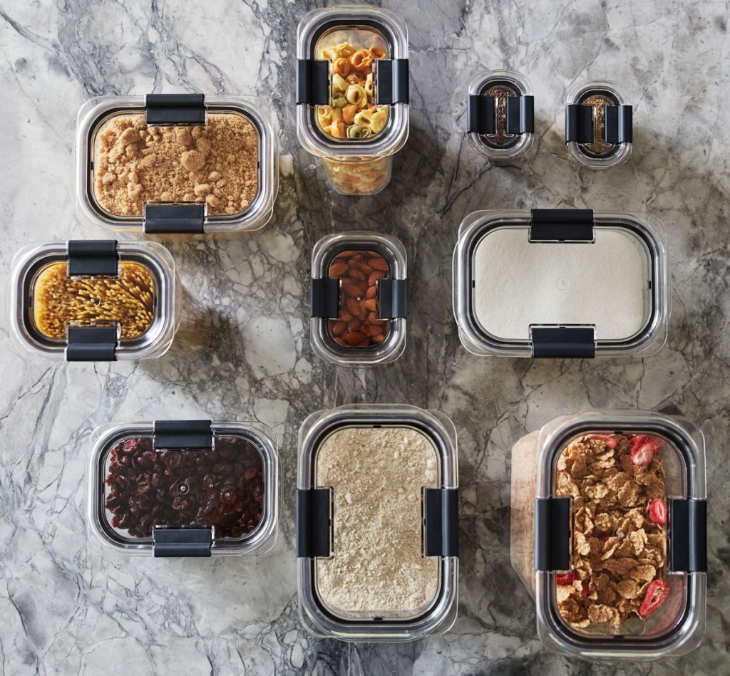 set of clear food storage containers with various foods inside on a kitchen counter
