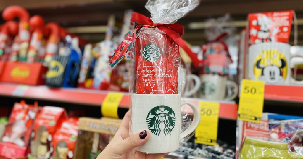 hand holding Starbucks mug and cocoa gift set in store