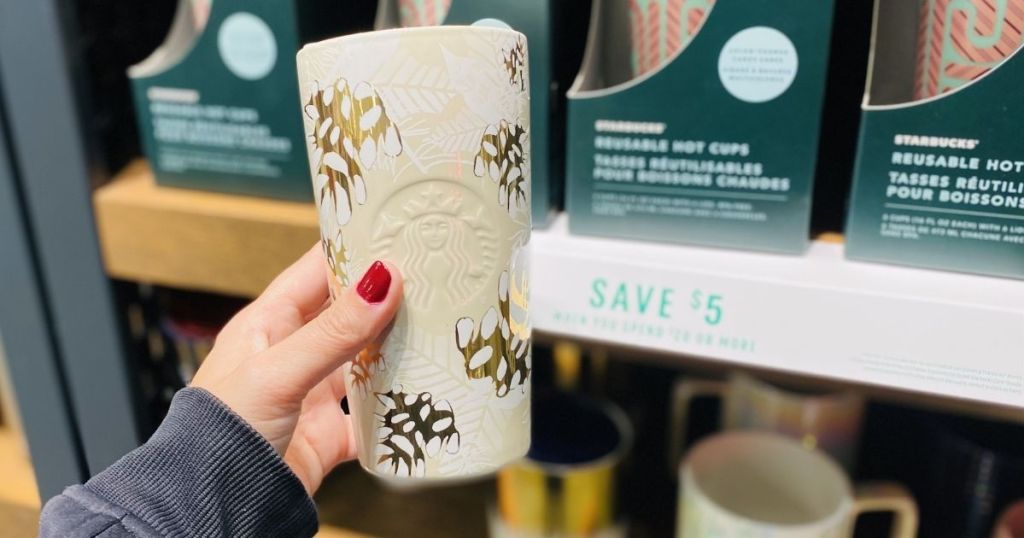 hand holding a Starbucks mug